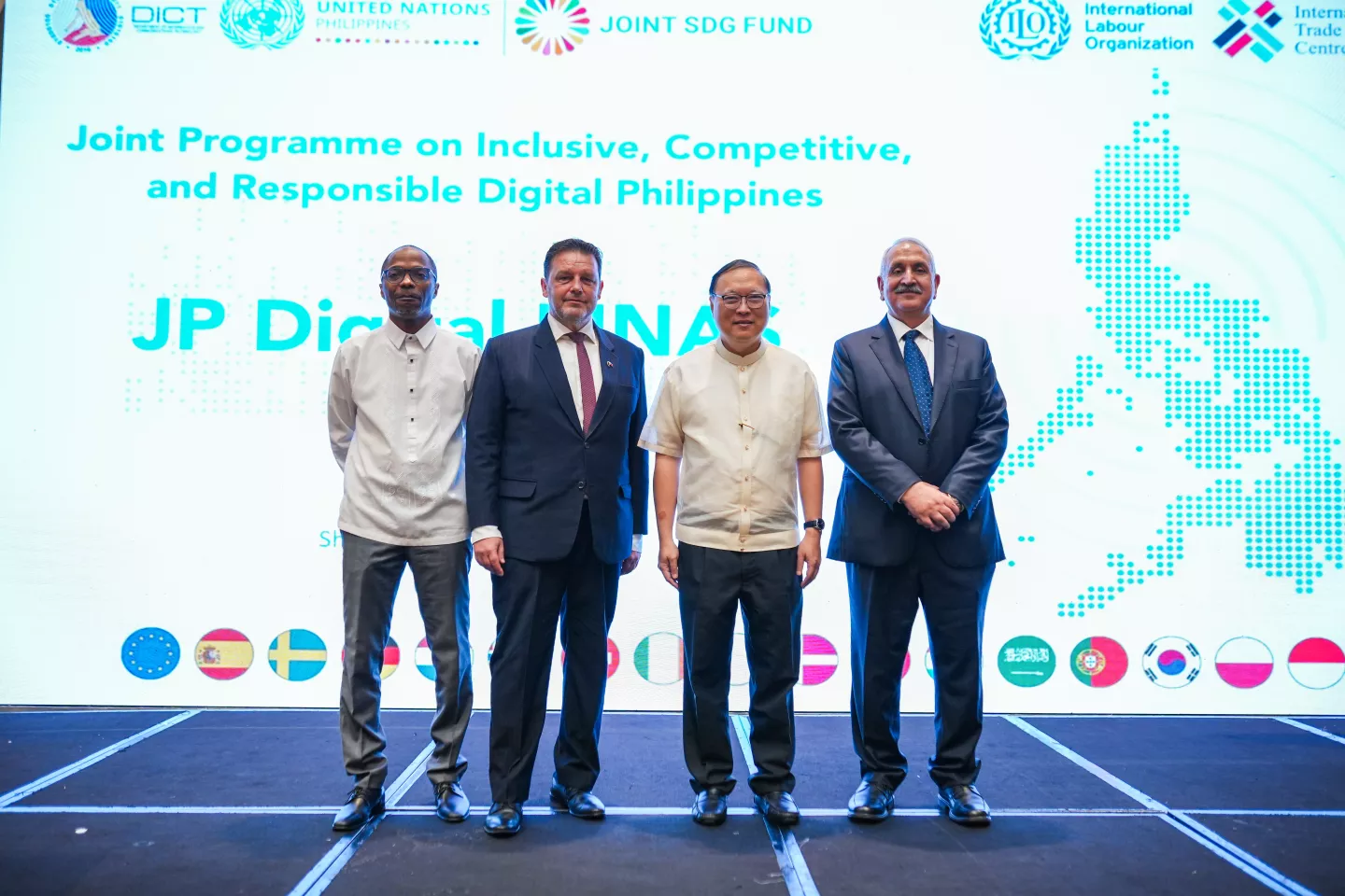 Four men posing on stage at the launch of a digital initiative in the Philippines